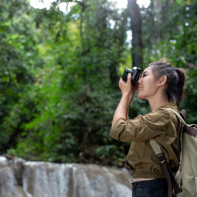 female-hikers-take-pictures-themselves Female hikers take pictures of themselves with beautiful waterfalls. Relax after hiking