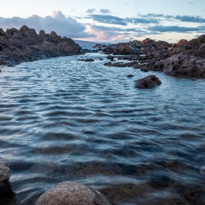 Water with stones in it sorounded with rocks Pure water with stones in it sorounded with rocks